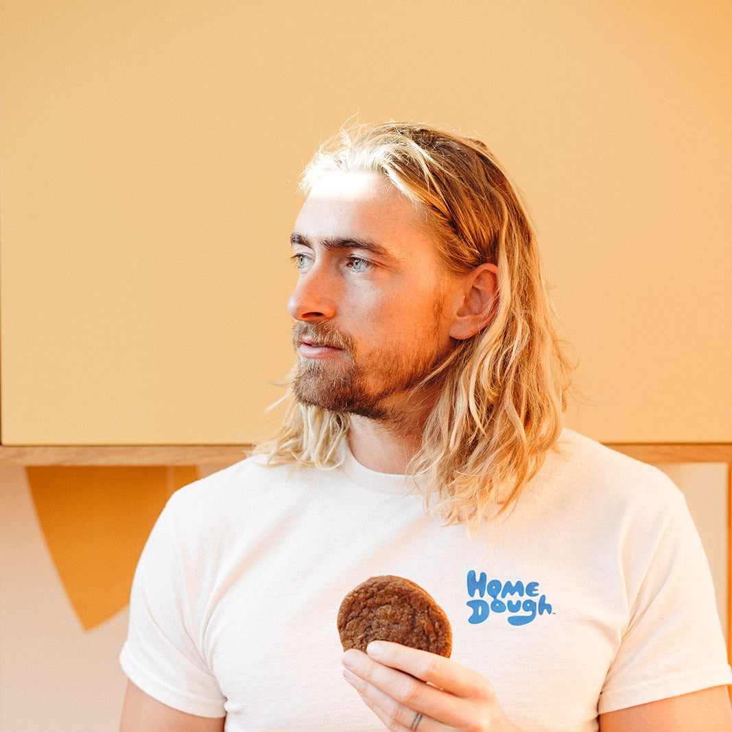 Man holding a fresh-baked Molasses Ginger Spice Cookie